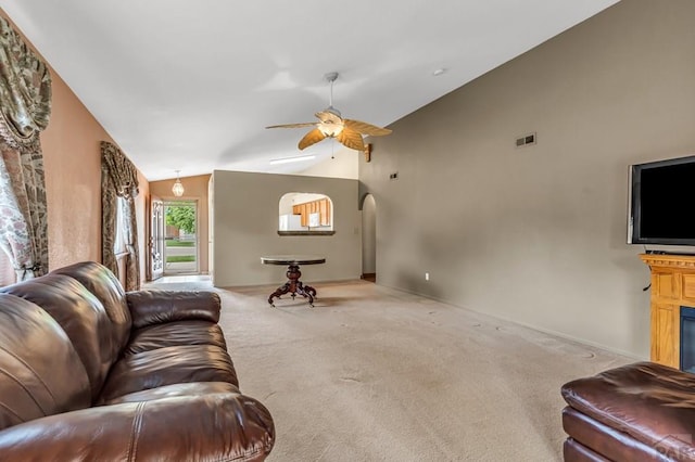 5048 Sage St, Pueblo, CO 81005 - living area with carpet floors, vaulted ceiling, ceiling fan, arched walkways, and a fireplace