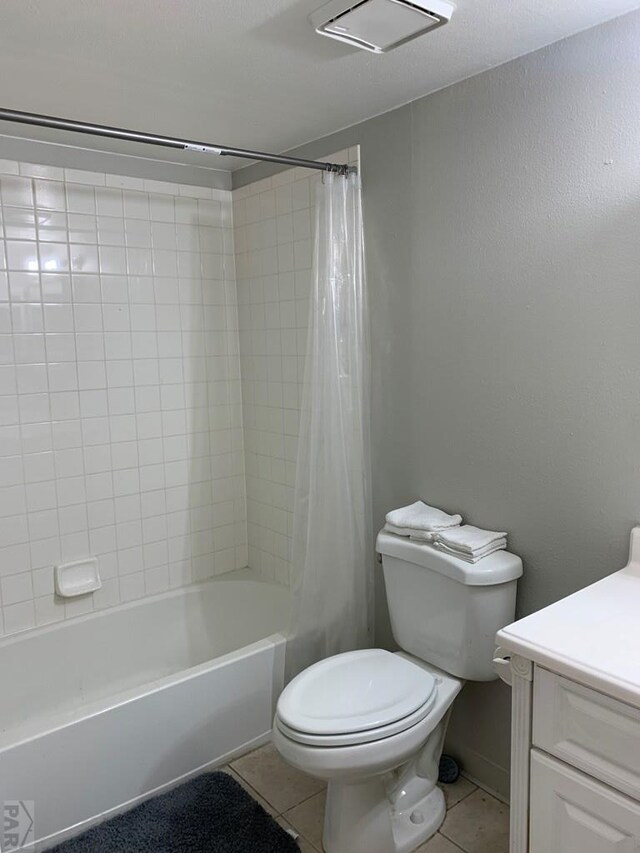 full bathroom with shower / tub combo with curtain, vanity, toilet, and tile patterned floors