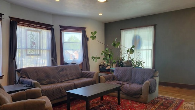 living room with recessed lighting, baseboards, and wood finished floors