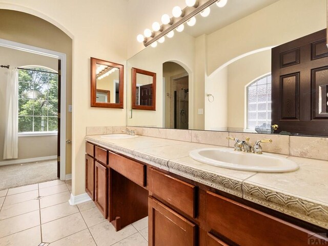 1705 Aquila Dr, Pueblo, CO 81008 - bathroom with double vanity, tile patterned flooring, and baseboards