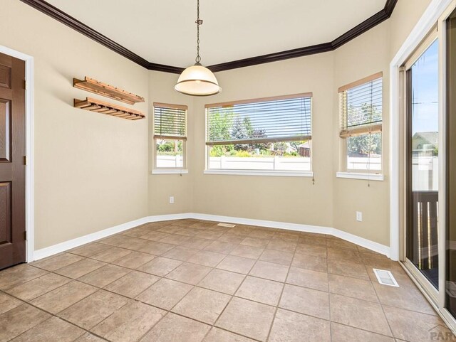 1705 Aquila Dr, Pueblo, CO 81008 - unfurnished dining area with ornamental molding, light tile patterned floors, and baseboards
