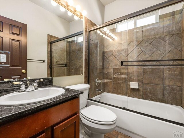 1705 Aquila Dr, Pueblo, CO 81008 - bathroom with vanity, toilet, and bath / shower combo with glass door