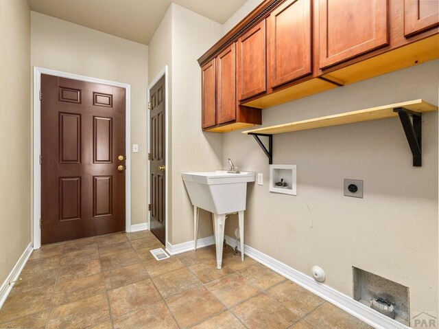 1705 Aquila Dr, Pueblo, CO 81008 - laundry area featuring cabinet space, hookup for a washing machine, baseboards, and hookup for an electric dryer