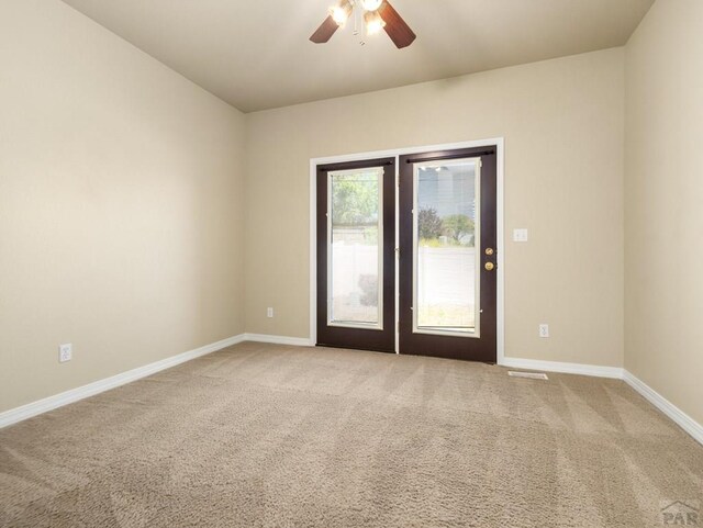 1705 Aquila Dr, Pueblo, CO 81008 - spare room with light colored carpet, ceiling fan, and baseboards