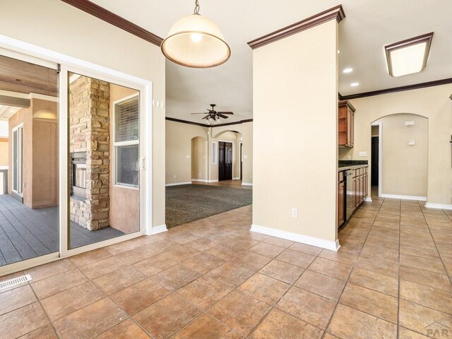 1705 Aquila Dr, Pueblo, CO 81008 - spare room featuring arched walkways, ornamental molding, baseboards, and ceiling fan
