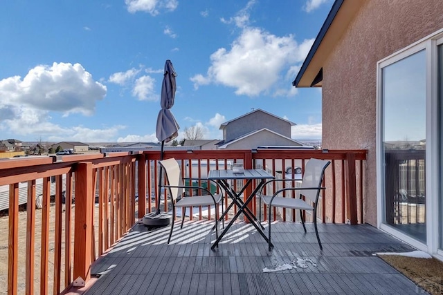 wooden terrace with outdoor dining area