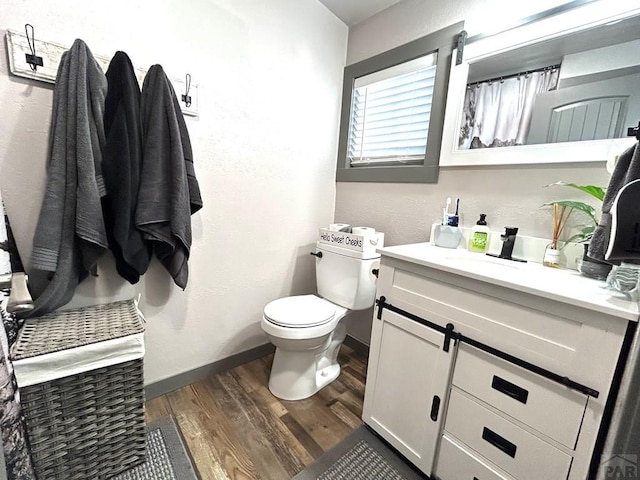 74 James Ave, Westcliffe, CO 81252 - full bath with wood finished floors, toilet, baseboards, and vanity