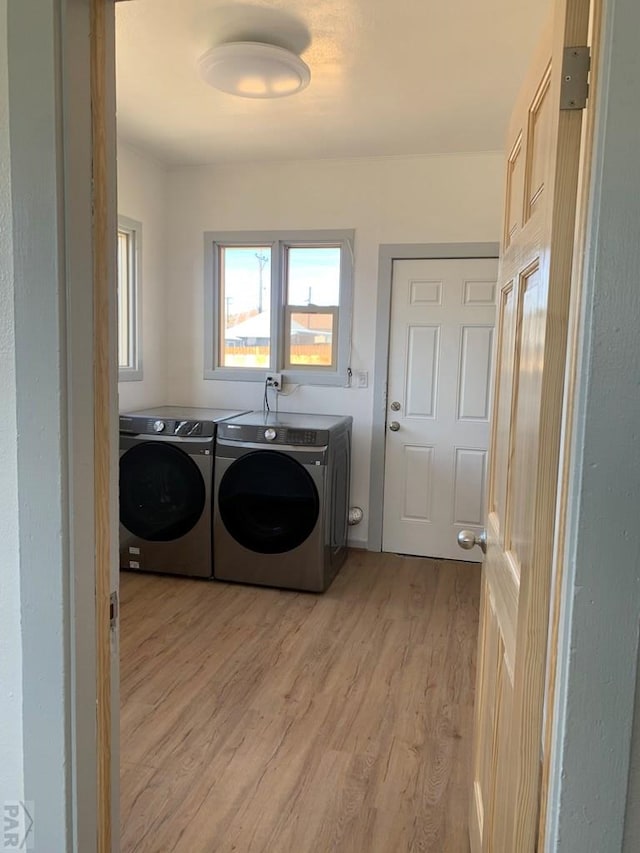 309 Walsen Ave, Walsenburg, CO 81089 - washroom with laundry area, light wood finished floors, and washing machine and clothes dryer