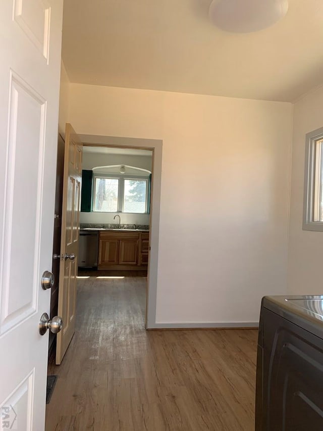 309 Walsen Ave, Walsenburg, CO 81089 - laundry area featuring dark wood-style floors, a sink, washer / dryer, laundry area, and baseboards