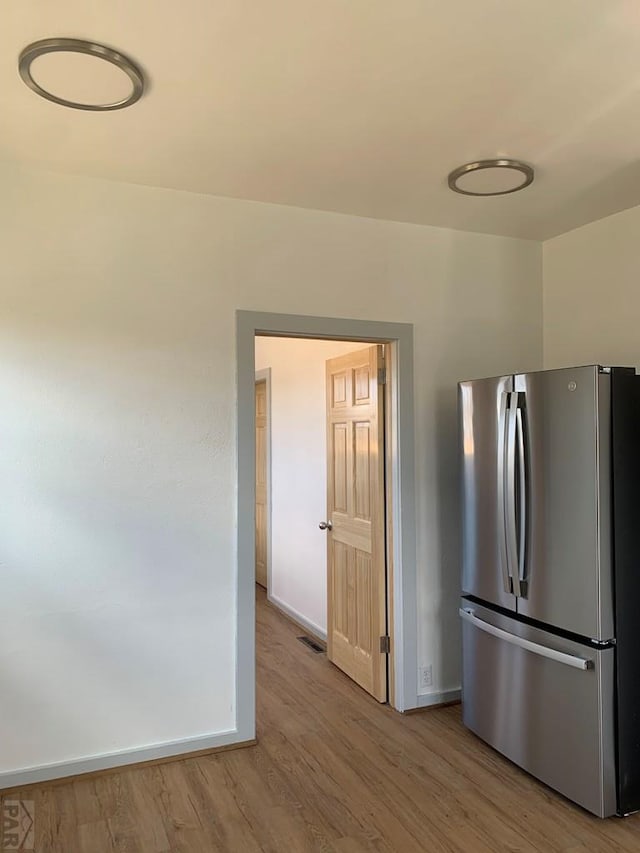 309 Walsen Ave, Walsenburg, CO 81089 - kitchen featuring light wood-style floors, baseboards, visible vents, and freestanding refrigerator
