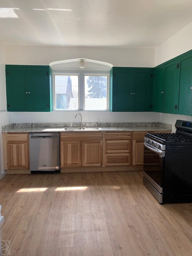 309 Walsen Ave, Walsenburg, CO 81089 - kitchen featuring a sink, stainless steel appliances, light countertops, and light wood-style floors