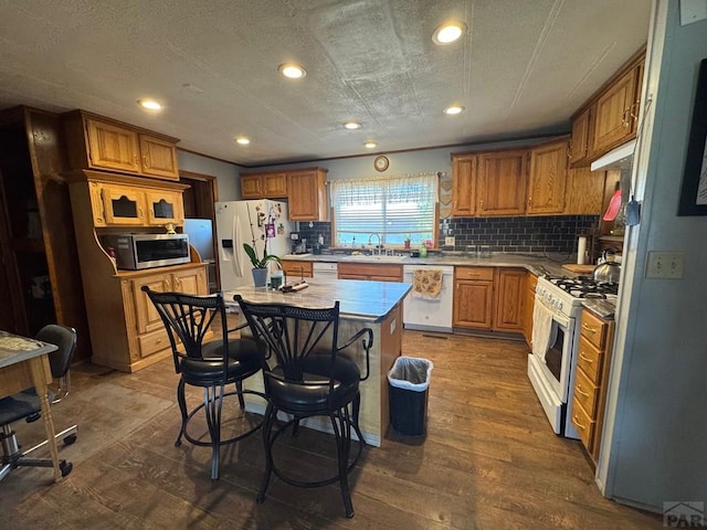 604 Townsend Ave, Olney Springs, CO 81062 - kitchen featuring white appliances, a sink, decorative backsplash, recessed lighting, and light countertops