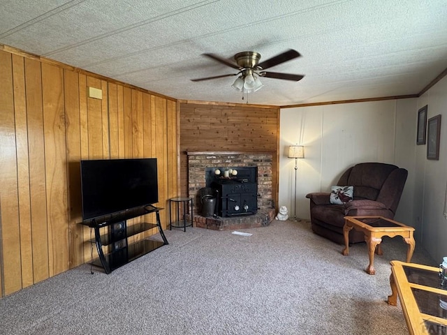 604 Townsend Ave, Olney Springs, CO 81062 - living area with ceiling fan, carpet floors, ornamental molding, and wood walls