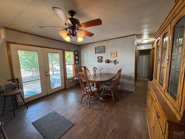 604 Townsend Ave, Olney Springs, CO 81062 - dining space with french doors, dark wood finished floors, crown molding, a ceiling fan, and a textured ceiling