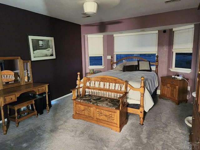 carpeted bedroom with baseboards and visible vents