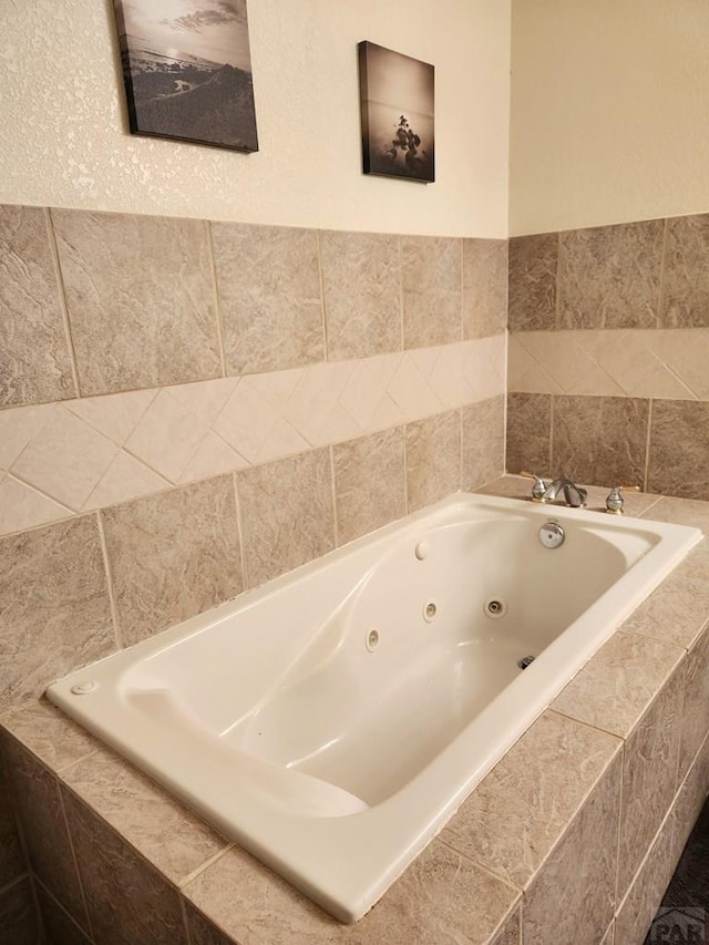 bathroom featuring a tub with jets