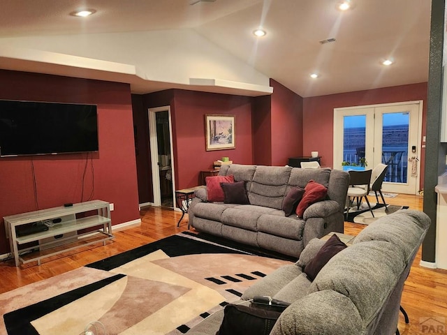 living area with wood finished floors, visible vents, baseboards, lofted ceiling, and recessed lighting