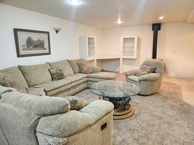 carpeted living room with a wood stove and recessed lighting