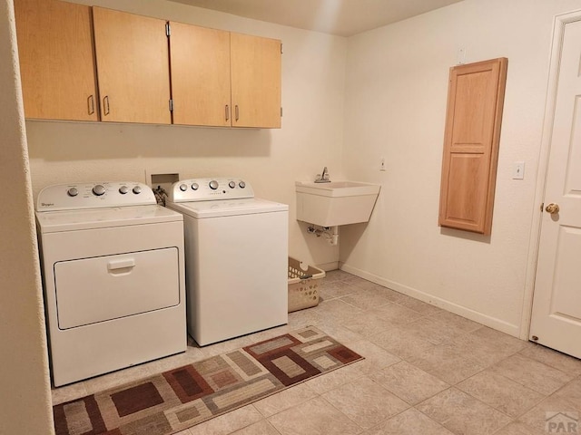 laundry area featuring cabinet space, independent washer and dryer, and baseboards