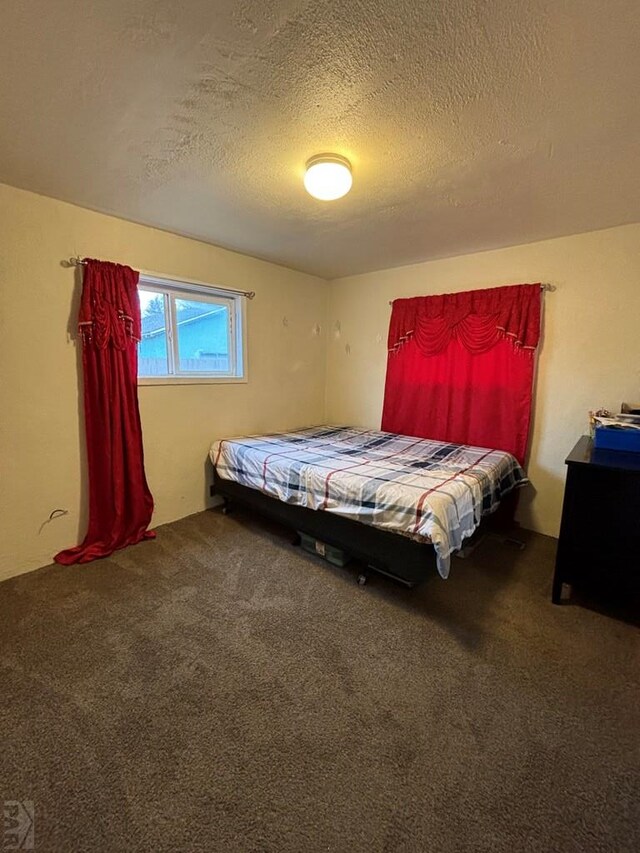 carpeted bedroom with a textured ceiling