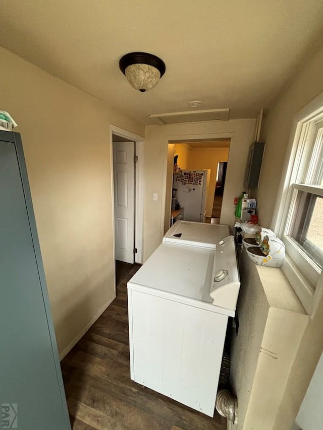 clothes washing area with independent washer and dryer and dark wood finished floors