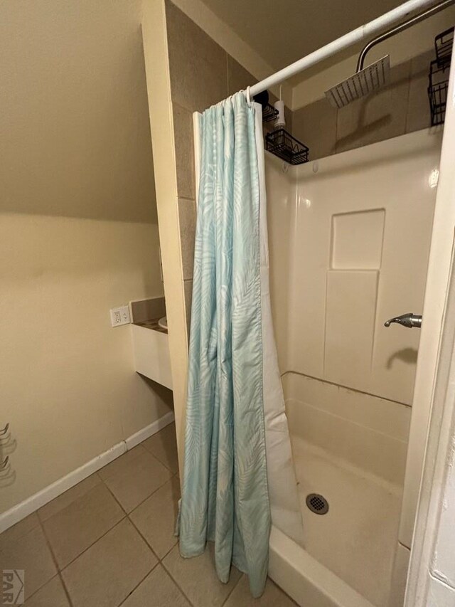 full bath featuring baseboards, a stall shower, and tile patterned floors