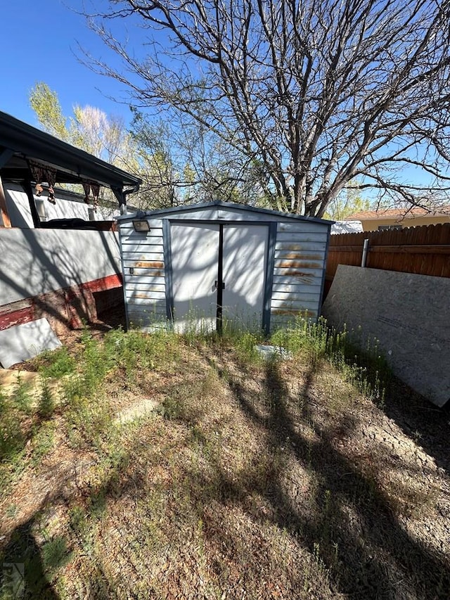 view of shed with fence
