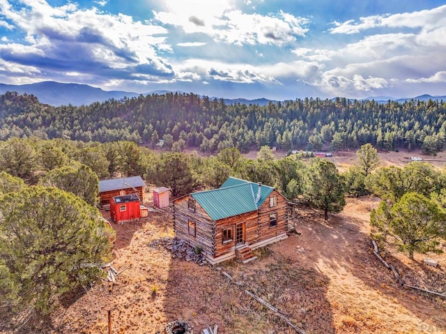 aerial view with a mountain view and a wooded view