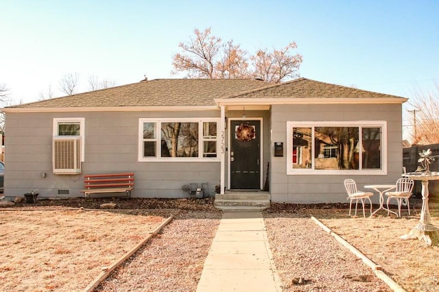 view of front of home with crawl space, entry steps, and roof with shingles