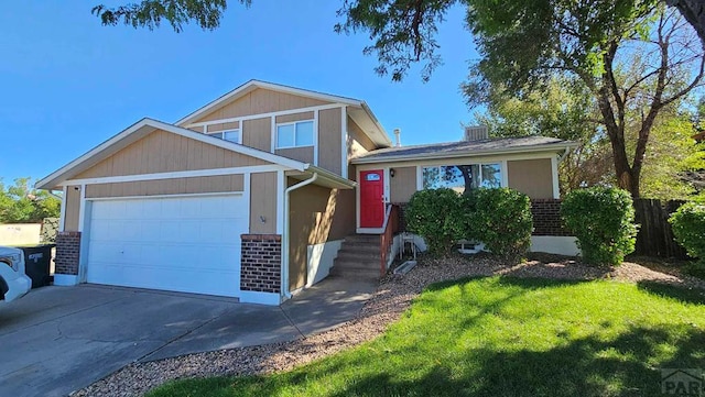 tri-level home featuring driveway, brick siding, and an attached garage