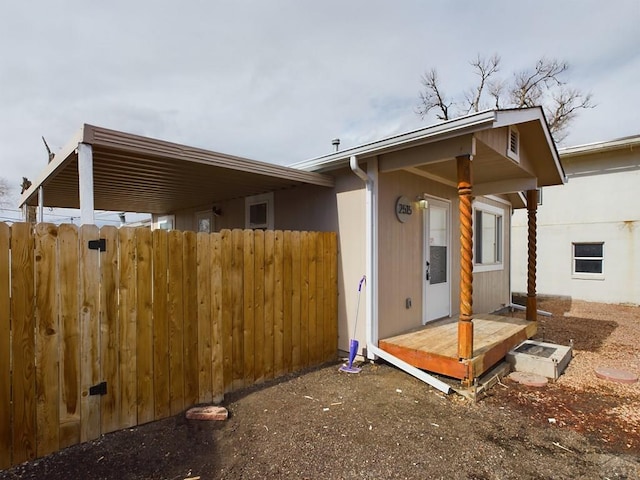 view of side of home featuring fence