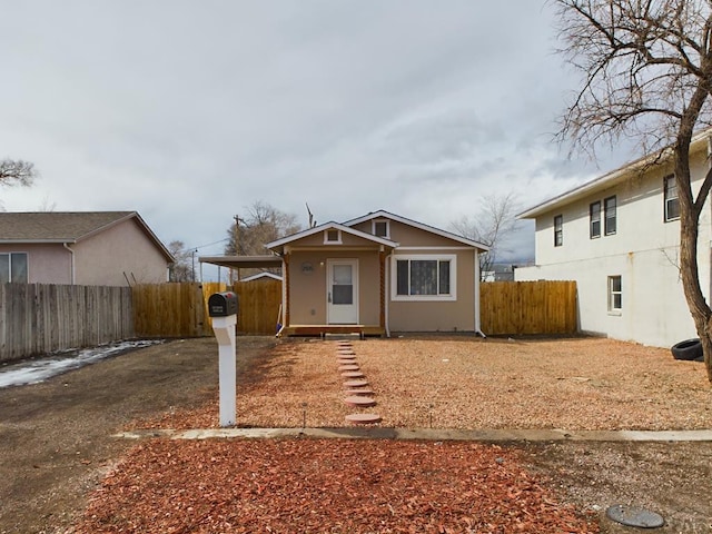 bungalow-style home with fence private yard