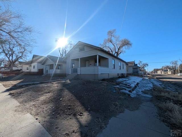 bungalow-style house with a residential view and fence