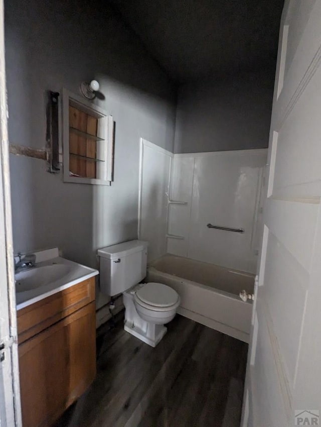 full bathroom featuring toilet, shower / bathtub combination, wood finished floors, and vanity