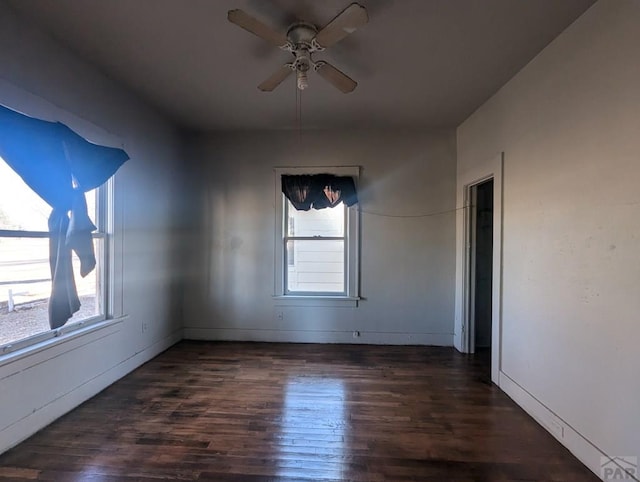 spare room with ceiling fan and dark wood finished floors