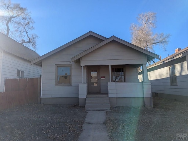 bungalow featuring fence