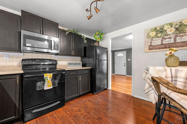 1516 Zuni Rd, Pueblo, CO 81001 - kitchen with black appliances, light countertops, backsplash, and dark wood finished floors