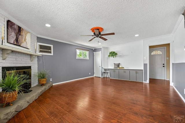 1516 Zuni Rd, Pueblo, CO 81001 - unfurnished living room with a textured ceiling, ceiling fan, wood-type flooring, a wall unit AC, and ornamental molding
