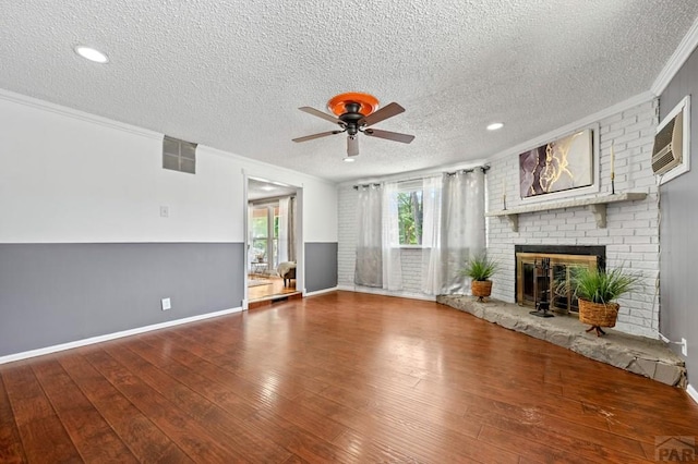 1516 Zuni Rd, Pueblo, CO 81001 - unfurnished living room with a textured ceiling, crown molding, a ceiling fan, wood-type flooring, and a brick fireplace