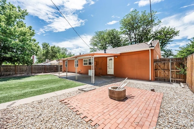 1516 Zuni Rd, Pueblo, CO 81001 - rear view of house featuring a patio, a fire pit, and a fenced backyard