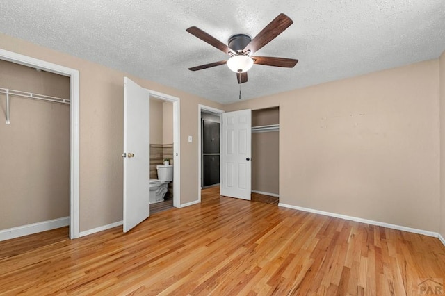 1516 Zuni Rd, Pueblo, CO 81001 - unfurnished bedroom with a textured ceiling, wood finished floors, two closets, and a ceiling fan