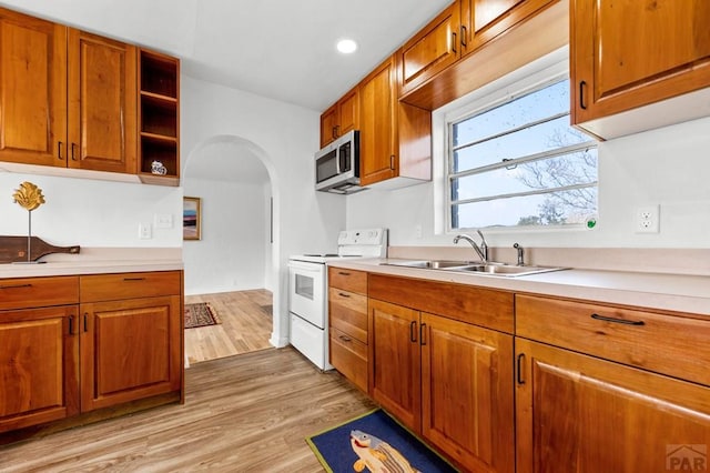 501 E Main St, Trinidad, CO 81082 - kitchen with white range with electric cooktop, a sink, light countertops, arched walkways, and recessed lighting