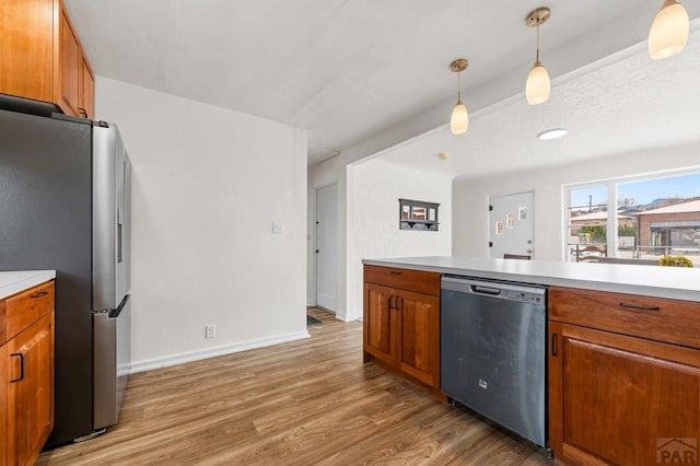 501 E Main St, Trinidad, CO 81082 - kitchen with appliances with stainless steel finishes, brown cabinetry, light wood-style flooring, and light countertops