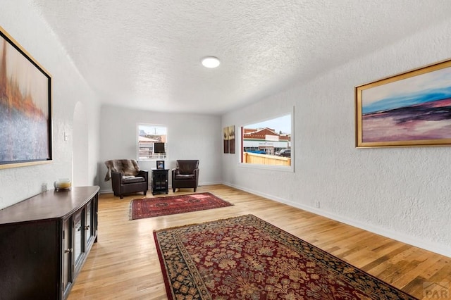 501 E Main St, Trinidad, CO 81082 - office featuring a textured wall, light wood finished floors, a textured ceiling, arched walkways, and baseboards