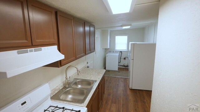 1434 E Evans Ave, Pueblo, CO 81004 - kitchen featuring freestanding refrigerator, range, brown cabinets, washer / dryer, and a sink
