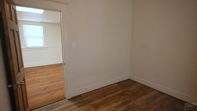 1434 E Evans Ave, Pueblo, CO 81004 - unfurnished room featuring dark wood-style flooring and baseboards
