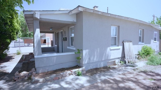 1434 E Evans Ave, Pueblo, CO 81004 - view of side of home featuring stucco siding and fence