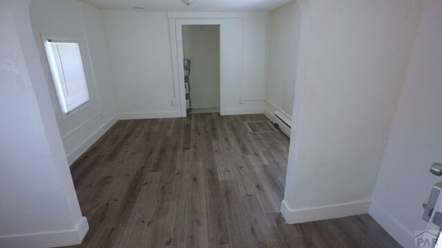 1434 E Evans Ave, Pueblo, CO 81004 - spare room with baseboards, wood finished floors, and a baseboard radiator