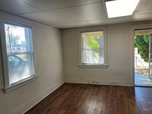 1434 E Evans Ave, Pueblo, CO 81004 - empty room with a healthy amount of sunlight, wood-type flooring, and a paneled ceiling