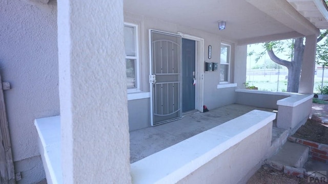 1434 E Evans Ave, Pueblo, CO 81004 - view of exterior entry with a porch and stucco siding